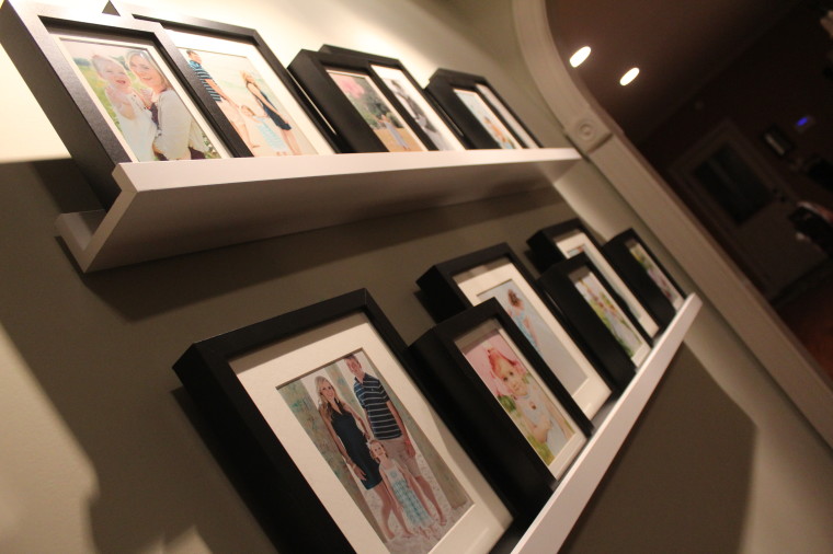 a closer look at the ledge shelving and photo wall